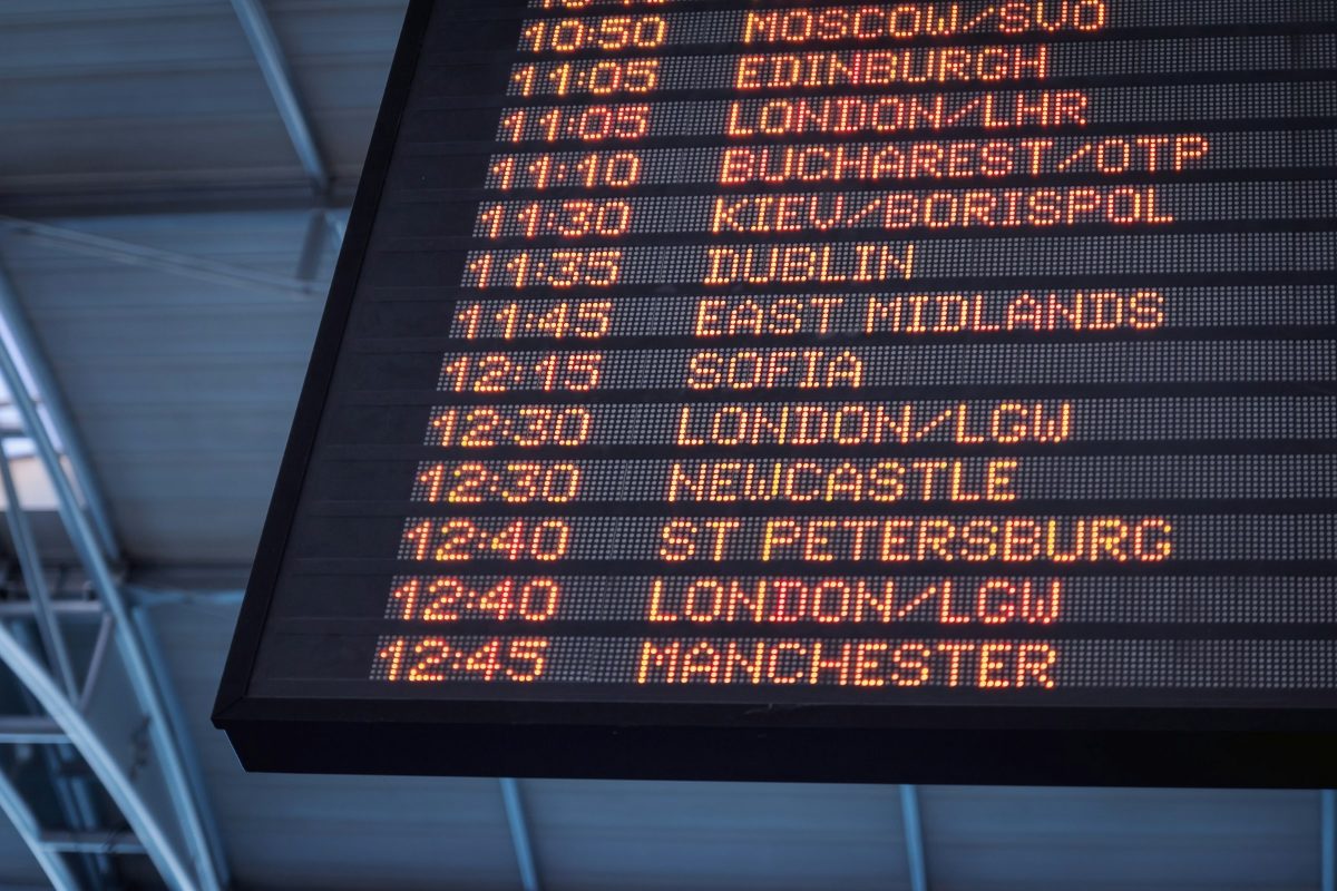 An airport departure board listing flights to Sofia, London, Dublin and other cities