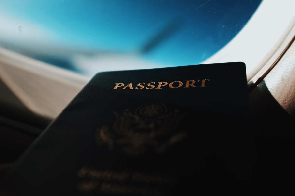 Passport silhouette framed by an aeroplane window