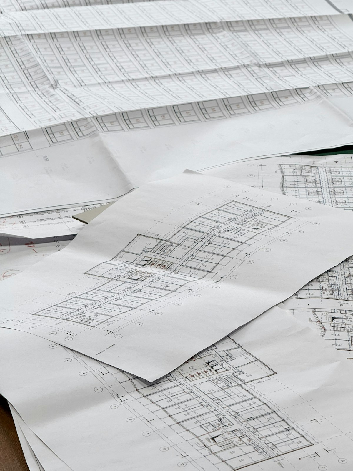 Architectural blueprints spread across a desk