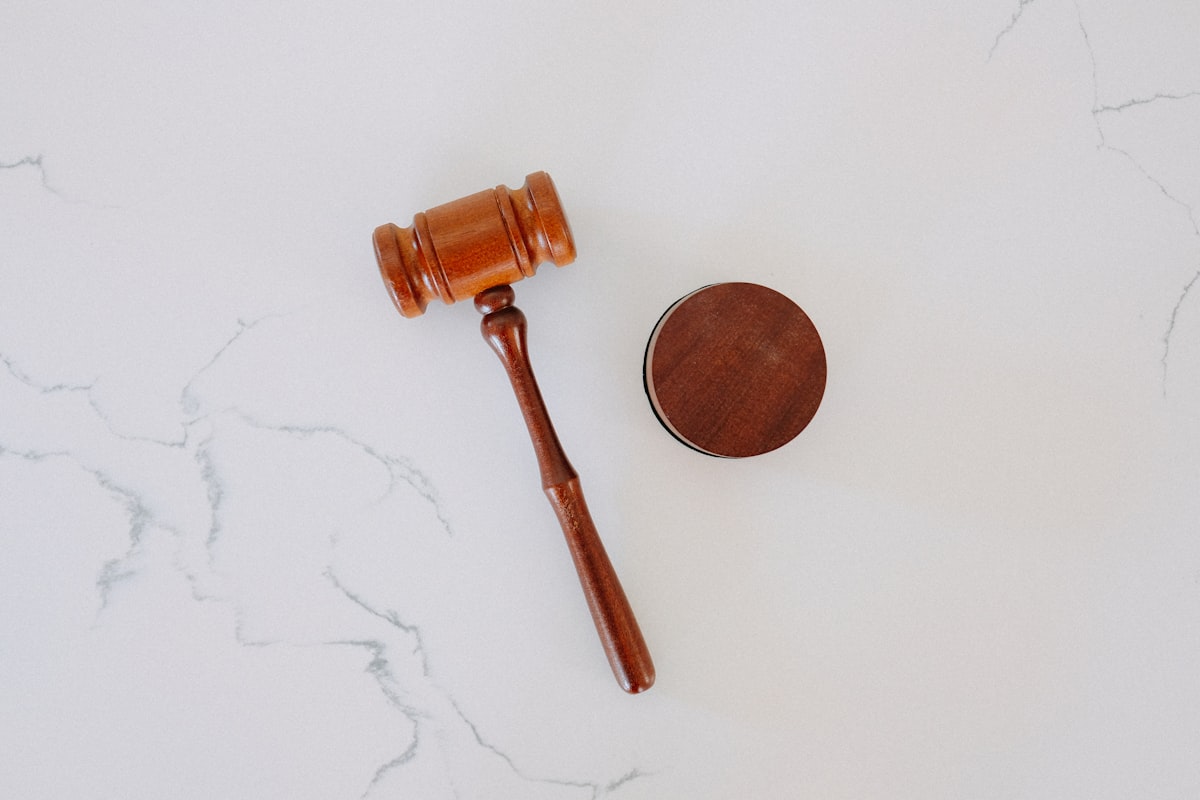 Wooden judge’s gavel resting on a marble block