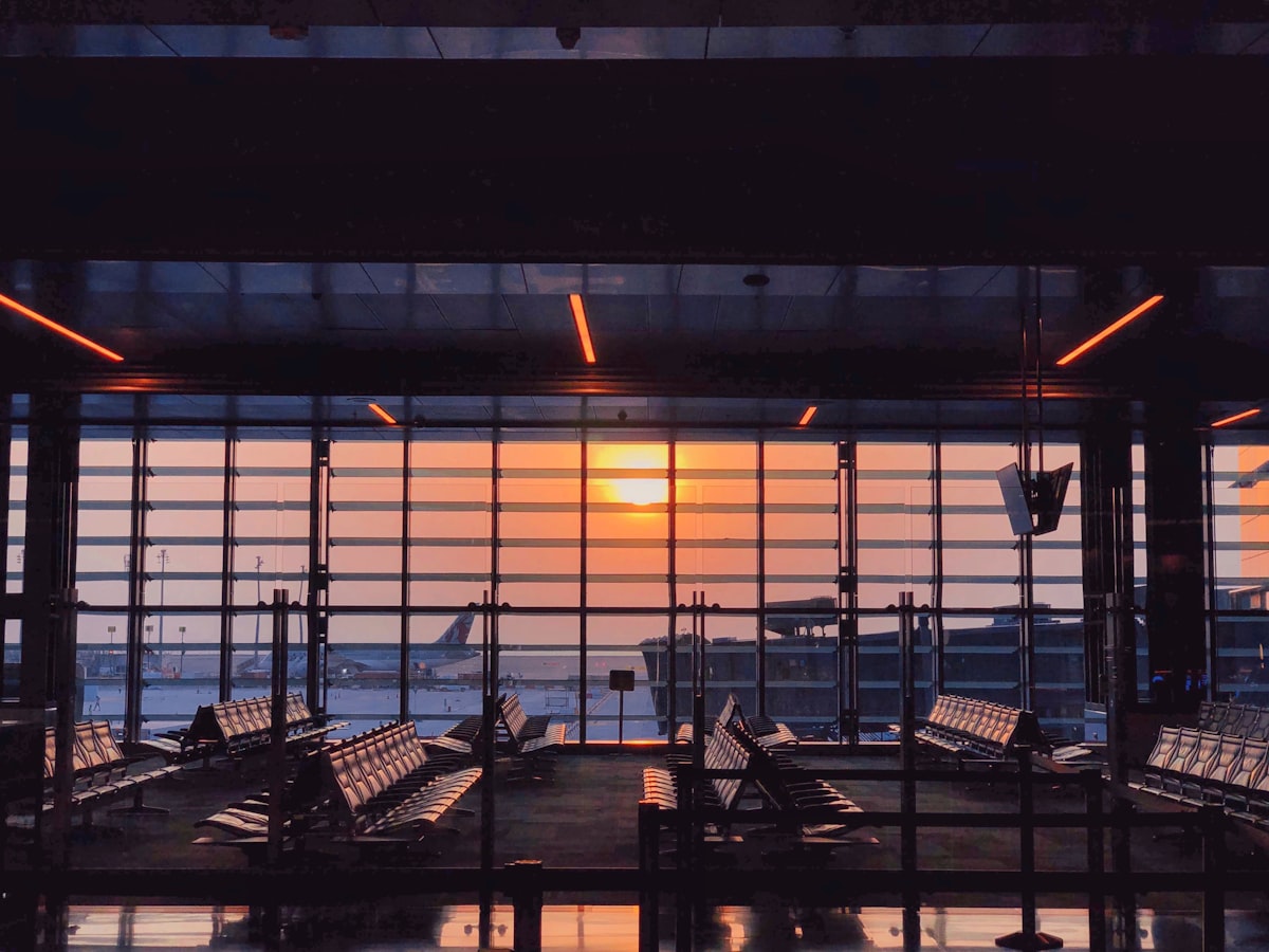 Sunset over the runway seen from an airport terminal