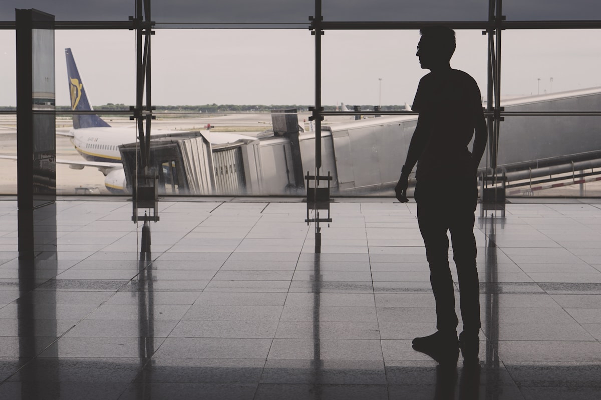 Quiet airport departure lounge with large windows